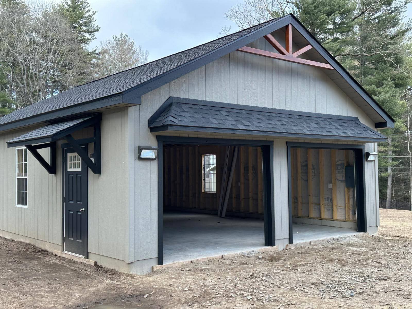 Single-level garage under construction — walls framed on site after the foundation is poured
