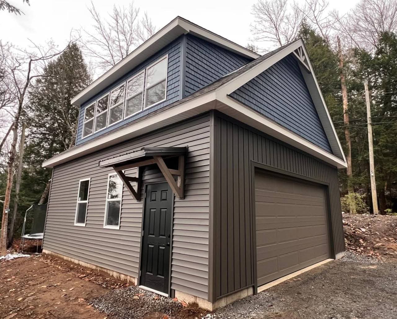 Two-story garage with dormers on both sides of the upper floor