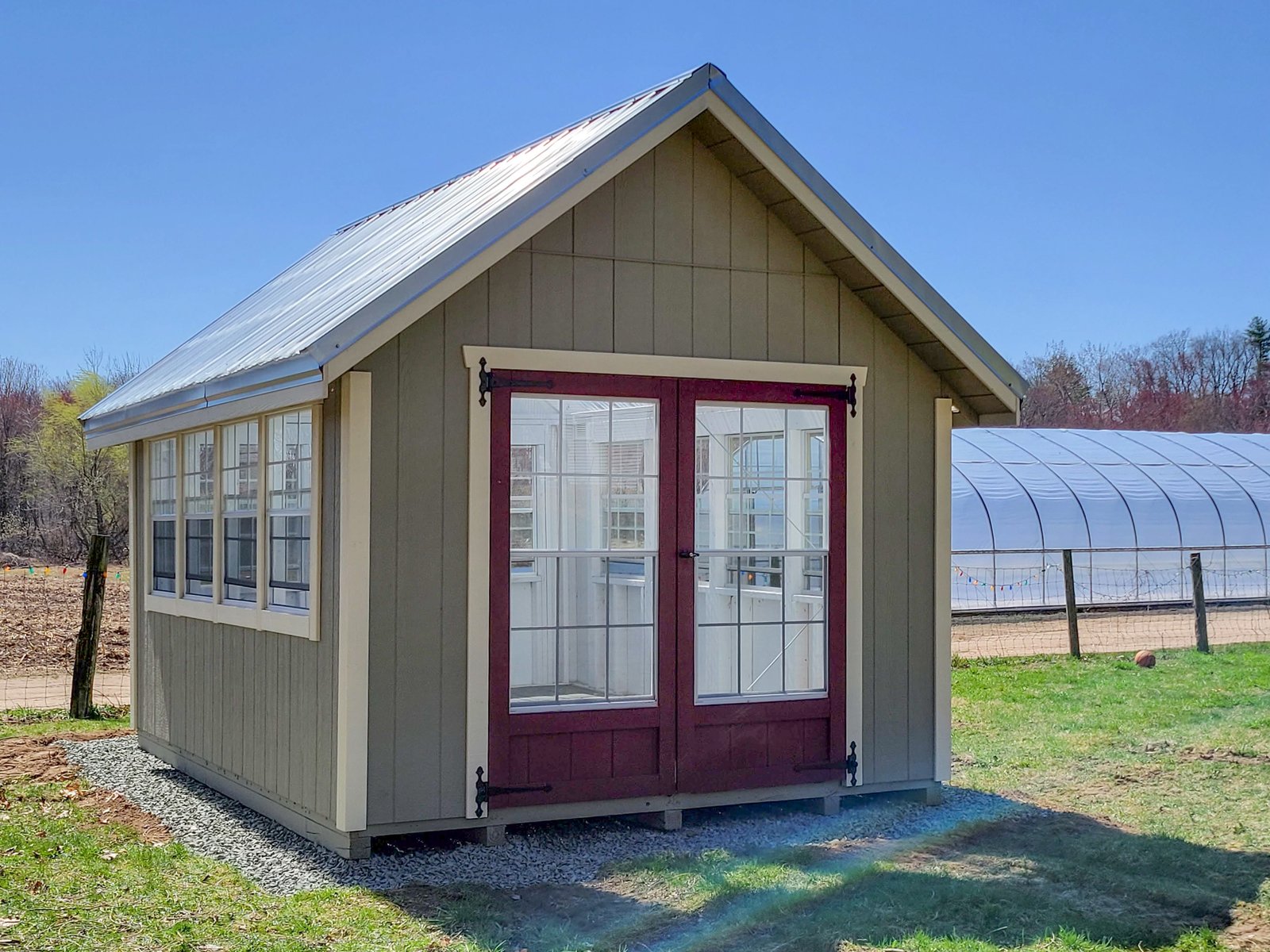 New england greenhouse on a gravel pad on a farm