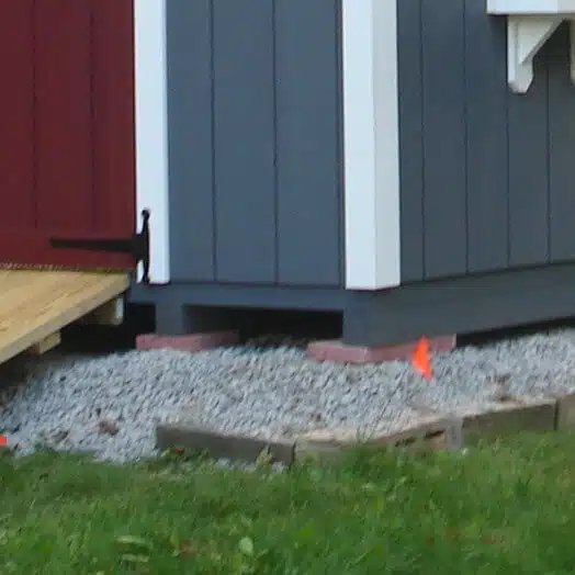 Storage shed set on blocks on an unlevel area