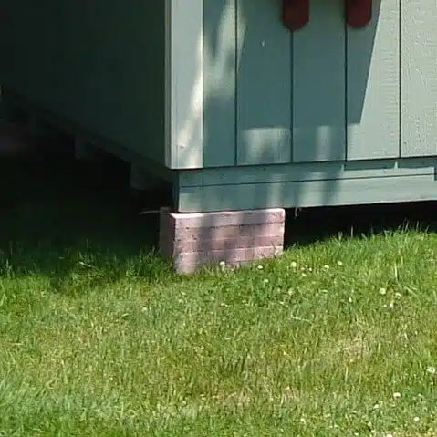 Storage shed sitting on an unstable stack of blocks